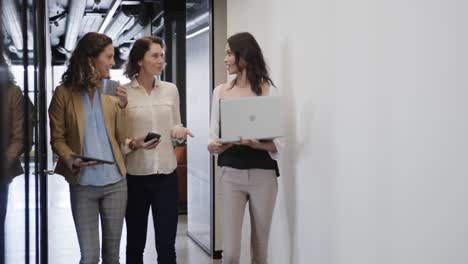 Montage-of-diverse-female-colleagues-working-in-office,-slow-motion