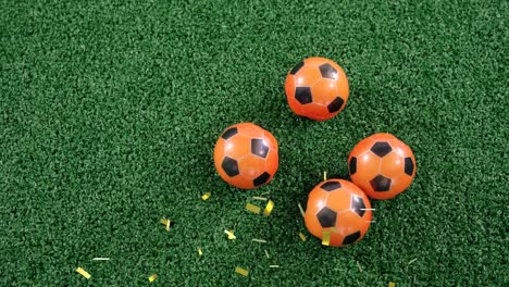 Animation-of-confetti-falling-over-soccer-balls