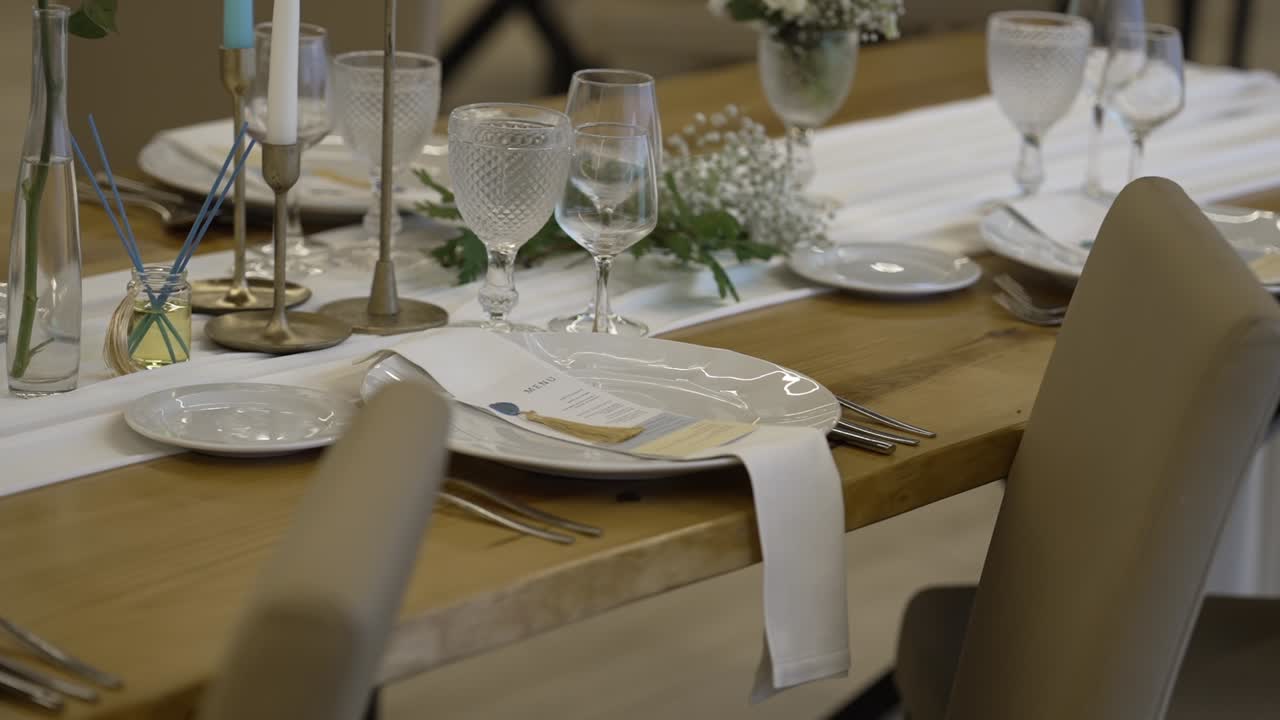 Close up of an elegant wedding table setup with glassware and decor