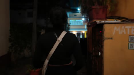 confident woman glancing back in alleyway