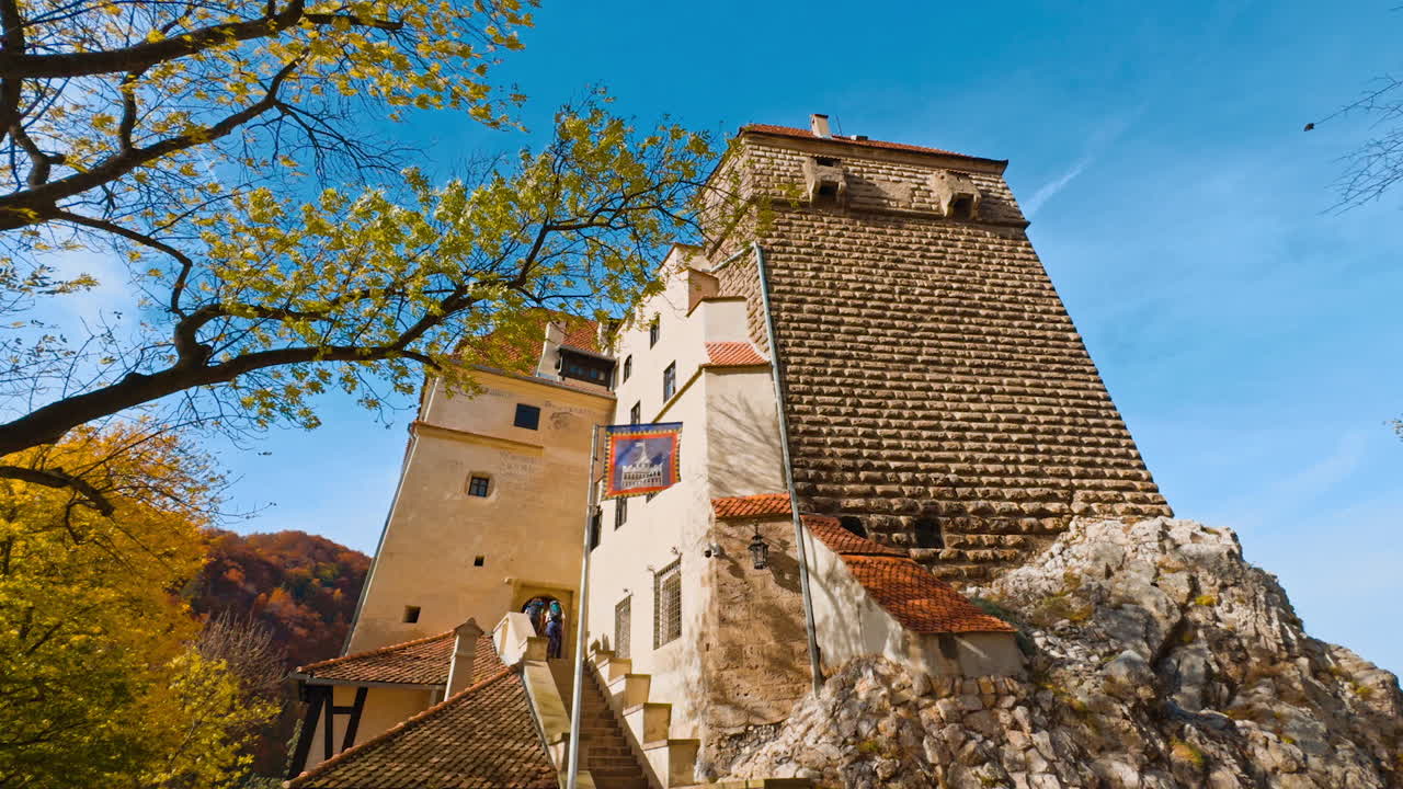 Beautiful sunny autumn day near the old castle. Count Dracula home place in Brasov, Romania. Low angle view.