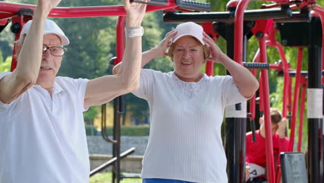 Senior citizens exercising at an outdoor gym in a park