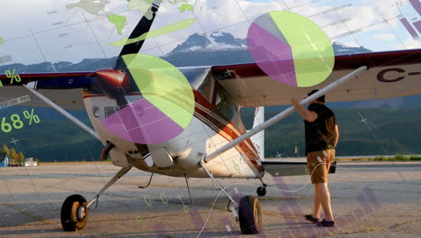 animation of infographic interface over caucasian man checking glider airplane