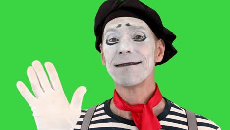 mime amistoso mostrando hola con su mano en una pantalla verde, clave de croma