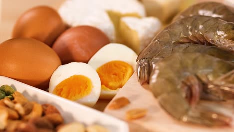 a close-up view of diverse protein sources including eggs, shrimp, chicken, and beef.
