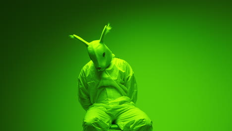 person in rabbit mask and green jumpsuit