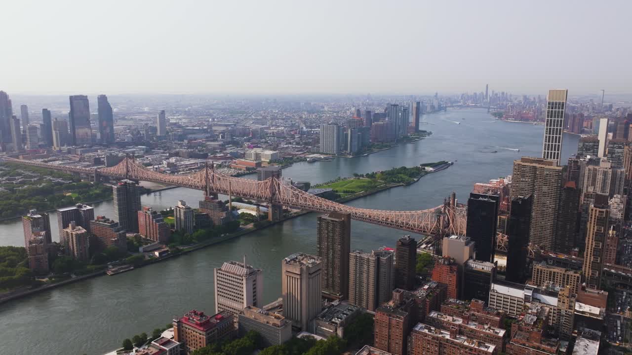 Aerial view ascending in front of the Queensboro Bridge and East river in NYC