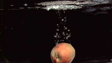 apple falling into water in super slow motion