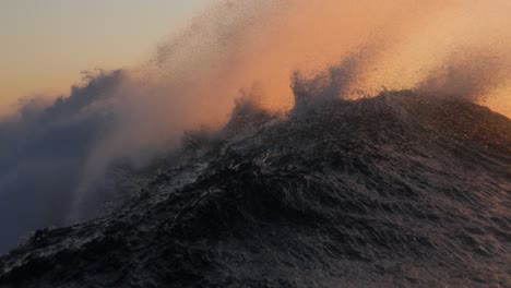 a short heavy wave crash over the shallow rock ledge