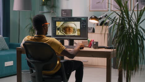 man editing photos on computer