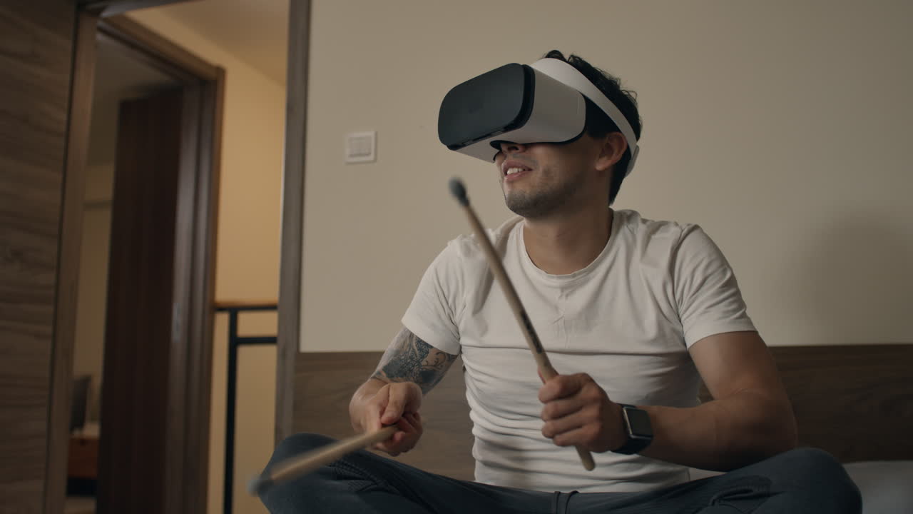 Man plays virtual drums with headset in modern apartment