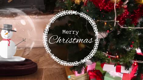 Animation-of-merry-christmas-in-wreath,-snowman-in-crystal-ball-over-fireplace-and-christmas-tree