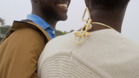 happy african american couple standing together o the beach 4k