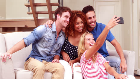 Smiling-friends-taking-selfies-with-smartphone