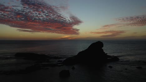 the romantic twilight colors of the sky from the rocky shores of the fiji islands - aerial