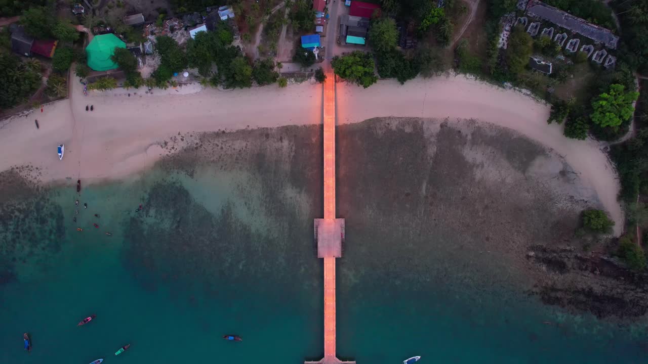 Aerial top-down glowing pier and deserted beach Koh Yao Yai, Thailand