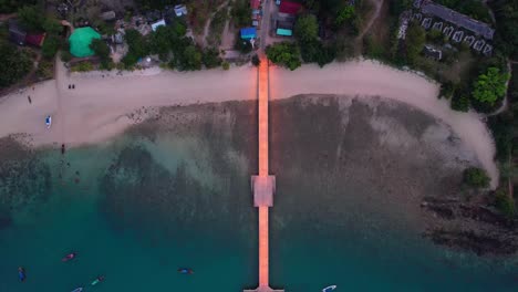 Aerial-top-down-glowing-pier-and-deserted-beach-Koh-Yao-Yai,-Thailand