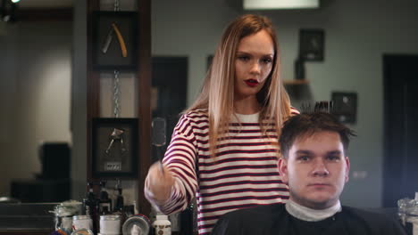 Close-up-hairdresser-with-scissors-and-comb.-Blurred-background.