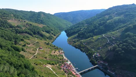 Mountainside Villages With A Flowing River Near O Saviñao Concello In The Province of Lugo, Galicia, Spain. Aerial Drone Shot