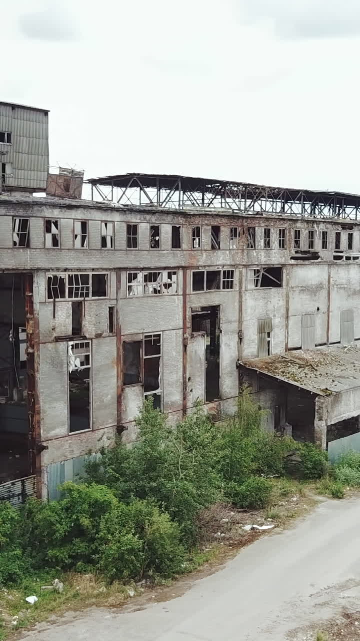 Abandoned ruined industrial factory building, ruins and demolition concept. Aerial view. Vertical video