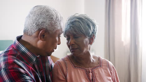 Senior-Man-Comforting-Woman-With-Depression-In-Bedroom-At-Home