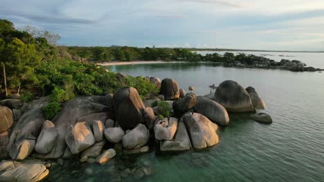 rocky coastline at sunset with granite boulders and