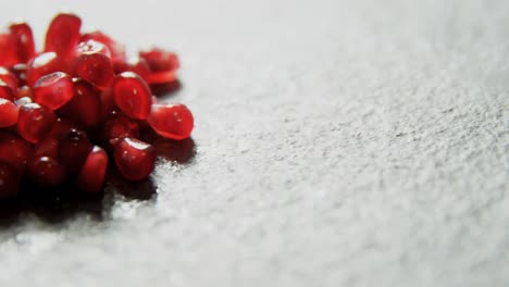 pomegranate seeds on grey background 4k 4k