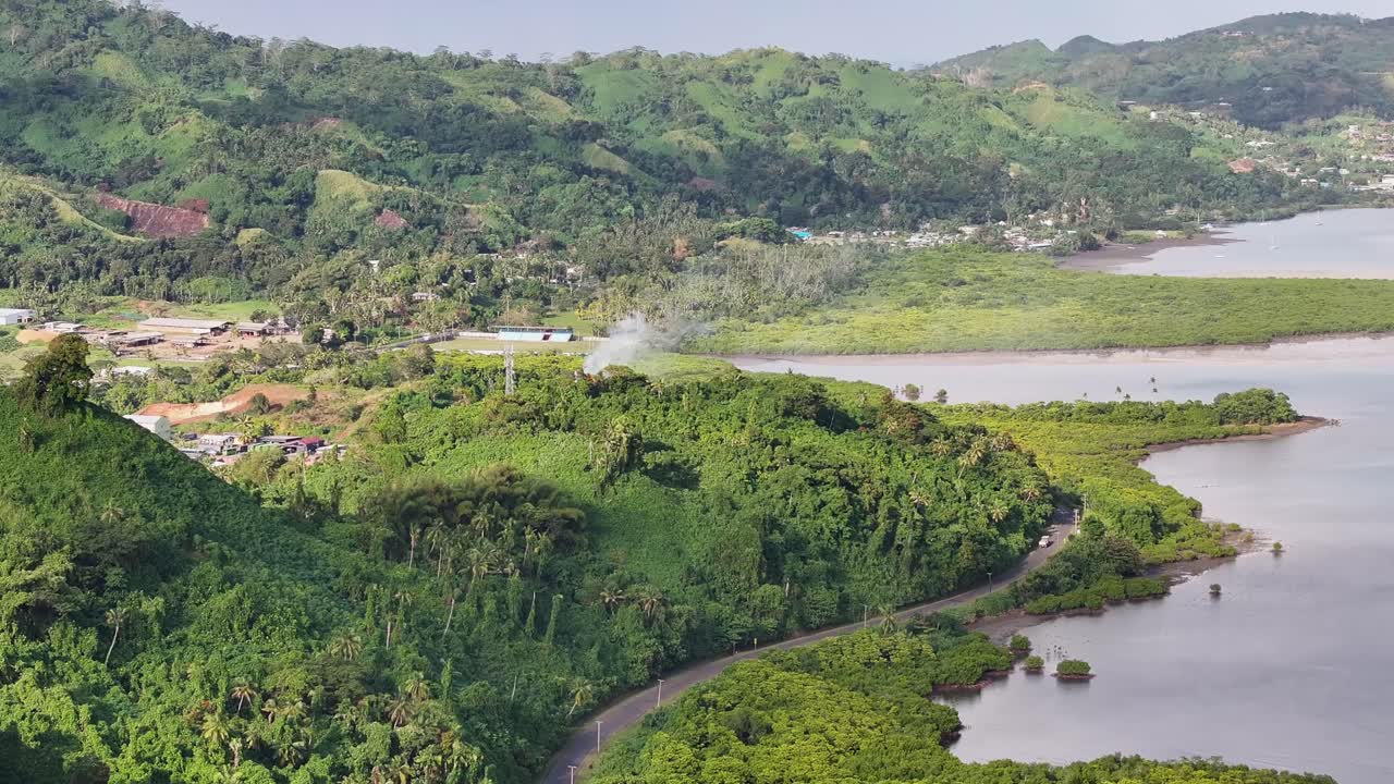 savusavu, vanua levu, fiji - un día soleado con paisajes tropicales, una carretera principal y una costa costera - fotografía aérea de un dron