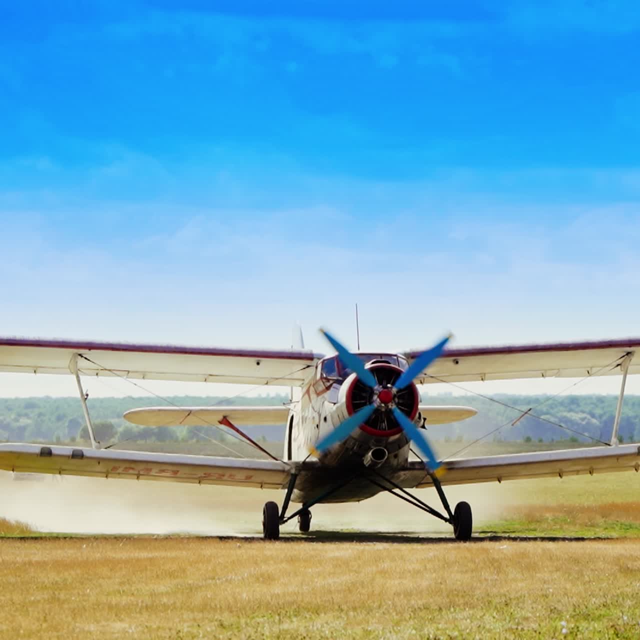Approaching airplane in the field. Aircraft landing in the farmland. Azure skies at backdrop