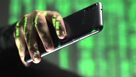 Vertical-closeup-of-green-code-text-rolling-over-smartphone-in-hand