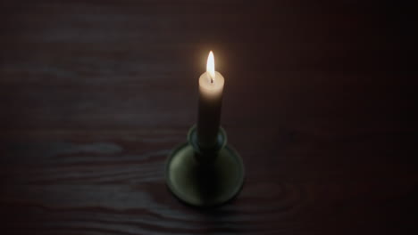a candle burs out in the dark room
