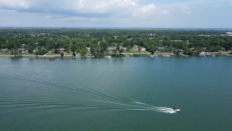 motorboats cruising in detroit river, near grosse ile, trenton michigan, usa