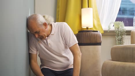 unhappy old man on his knees. exhausted.