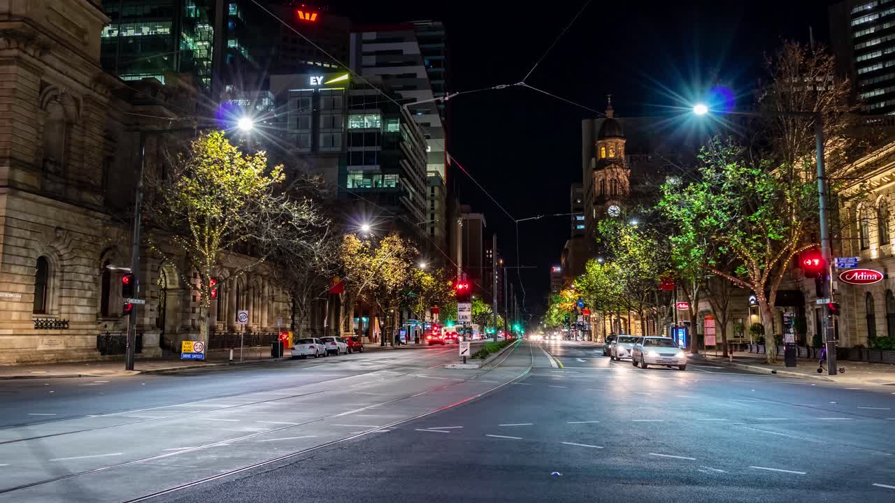 Timelapse at night of cars at the intersection of King William Street and Victoria Square.