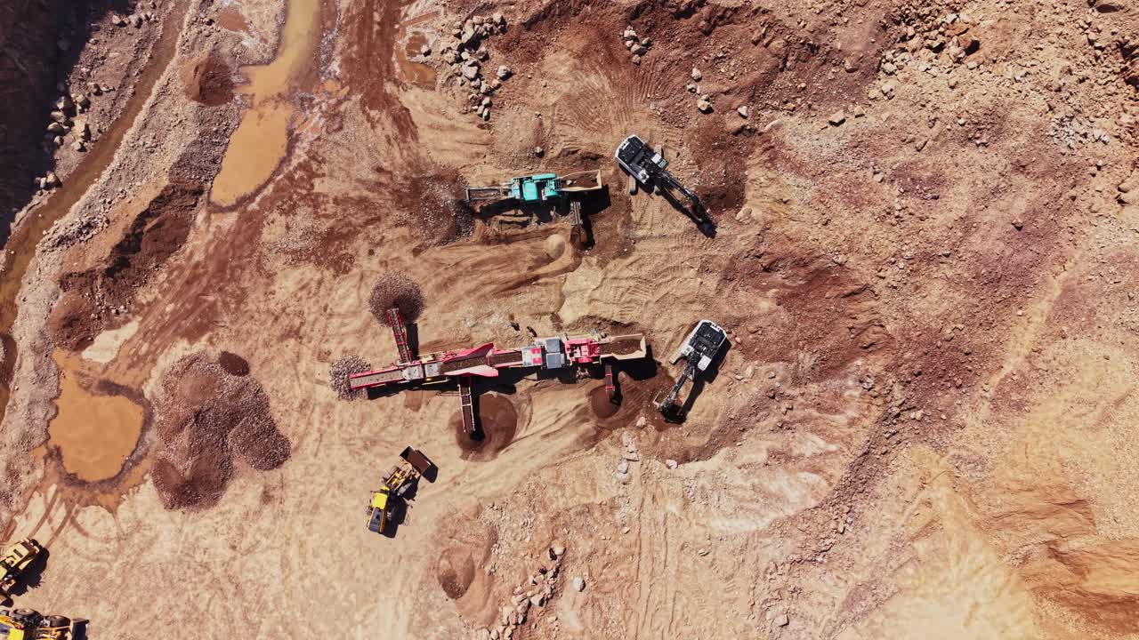 Mining operation in rocky terrain using heavy machinery and equipment
