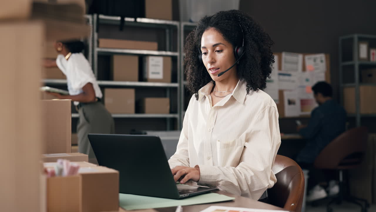 Woman in Headset Working on Laptop in E-commerce Office