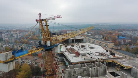 view from above on construction site with crane. big construction crane on a building background. aerial view. slow motion.
