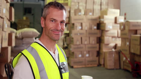 warehouse worker sending a text on his break