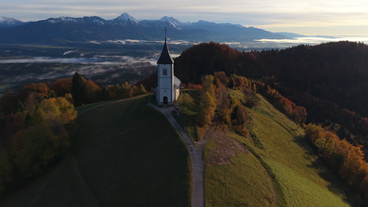 Spectacular aerial view flying away from the famous church of Saints Primus and Felician at sunrise