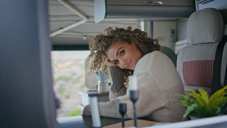 lady traveller sitting trailer looking camera with smile close up. woman posing