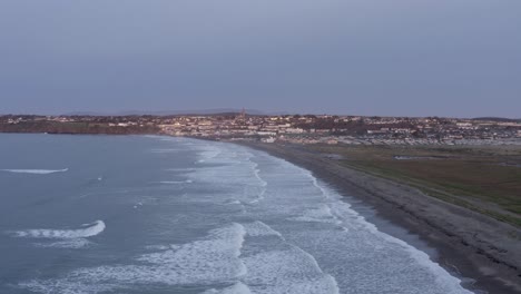 Morgendämmerung-Antenne-Entlang-Tramore-Strand-In-Richtung-Küstenstadt-In-Irland