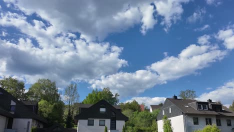 time-lapse: picturesque sky with white clouds over residential buildings