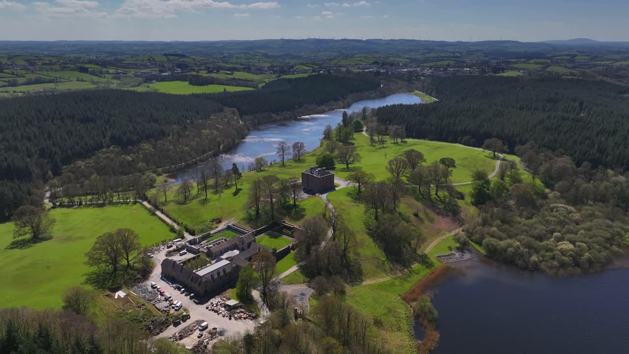 Bellamont House, County Cavan, Ireland, April 2023. Drone orbits clockwise over historic estate, trees and countryside, scenic aerial view with vibrant natural beauty.