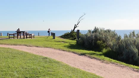 a woman walks her dog along the beach