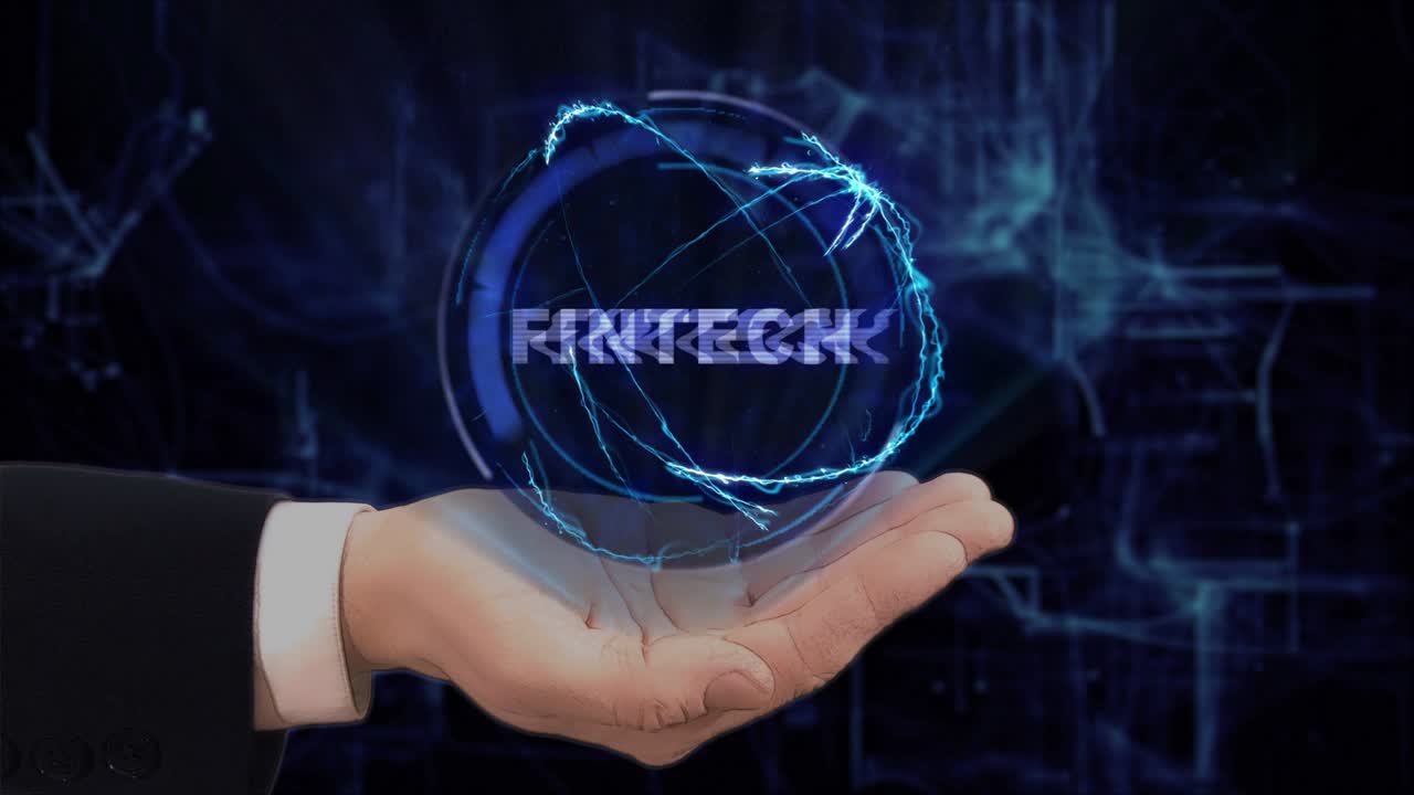 Painted hand shows concept hologram Fintech on his hand