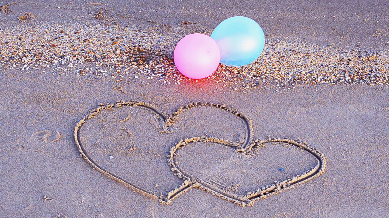 Two hearts on the beach. The loving hearts