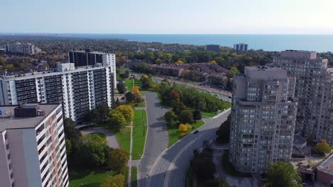 Apartment-buildings-in-beautiful-dense-populated-urban-city-with-roads,-trees,-parks,-cars-and-water