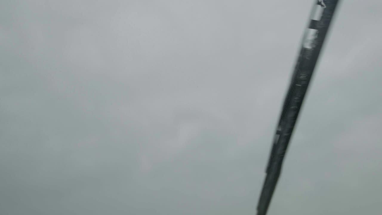 Premium stock video Car windshield wipers on rainy day slow motion close up