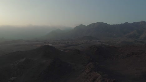 aerial - cinematic flying over mountains in hatta