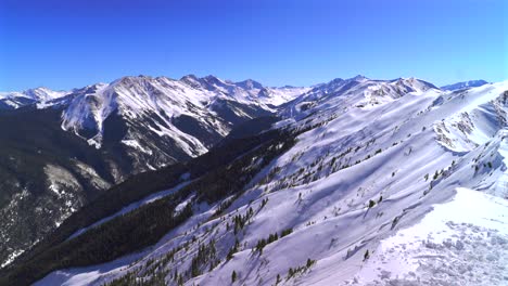 aspen highlands ski resort bowl backcountry skiing snowboarding high alpine steep terrain colorado landscape maroon bells capital peak wilderness blue sky winter deep snow sunny panorama landscape pan